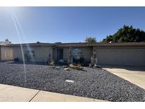 Charming single-story home featuring a well-kept yard with desert landscaping and an attached two-car garage at 4615 E Emerald Ave, Mesa, AZ 85206