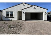 Charming single-story home with a spacious two-car garage and manicured front yard at 5628 W Summerside Rd, Laveen, AZ 85339