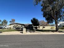 Charming single-story home with a well-manicured front yard and mature tree, offering great curb appeal at 6202 E Joan De Arc Ave, Scottsdale, AZ 85254