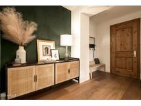 Welcoming entryway with a wooden door, stylish console table, and eye-catching decor creates an inviting first impression at 7175 E Camelback Rd # 401, Scottsdale, AZ 85251