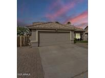 Charming single-story home with a two-car garage and beautifully maintained desert landscaping at 7252 E Nido Ave, Mesa, AZ 85209