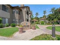 Beautiful entrance with a large stone sign, lush landscaping, and well-maintained walkways leading to the building at 9600 N 96Th St # 257, Scottsdale, AZ 85258