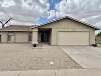 Charming single-story home with a neutral color palette and low-maintenance landscaping at 1512 N Iowa St, Chandler, AZ 85225