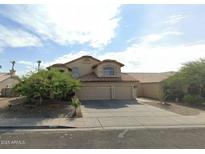 Charming two-story home with three-car garage and desert landscaping at 2117 N 123Rd Dr, Avondale, AZ 85392