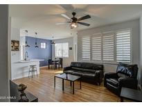 Bright living room with hardwood floors, stylish furnishings, and a modern ceiling fan at 3302 N 7Th St # 364, Phoenix, AZ 85014