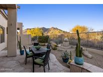 Outdoor patio features desert landscaping, stunning mountain views, and a comfortable seating area at 34423 N 68Th Way, Scottsdale, AZ 85266