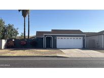 Charming single-story home featuring a well-maintained lawn and a two-car garage at 4231 E Carter Dr, Phoenix, AZ 85042