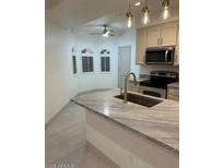 Modern kitchen with granite counters, stainless steel microwave, and ample cabinet space at 8653 E Royal Palm Rd # 1006, Scottsdale, AZ 85258