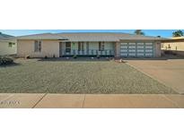 Charming single-story home with well-maintained front yard and attached two-car garage at 10509 W Oak Ridge Dr, Sun City, AZ 85351