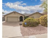 Charming home featuring a well-manicured front yard and a two-car garage at 14402 N Silverado Dr, Fountain Hills, AZ 85268