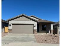 Charming single story home featuring a neutral color scheme, well maintained landscaping, and a two car garage at 16972 W Fetlock Trl, Surprise, AZ 85387