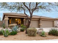 Charming single-story home with a well-maintained desert landscape and a three car garage at 17751 W Desert View Ln, Goodyear, AZ 85338