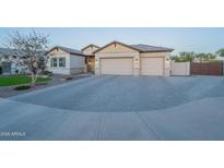 Charming single-story home featuring a spacious three-car garage and attractive desert landscaping at 21397 S 215Th Way, Queen Creek, AZ 85142