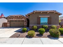 Charming single-story home with stone accents, desert landscaping, and a two-car garage at 21431 S 211Th Pl, Queen Creek, AZ 85142