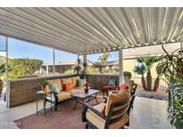 Comfortable covered patio featuring ample seating and views of the surrounding lush landscaping at 2263 N Trekell Rd # 113, Casa Grande, AZ 85122