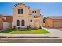 Two-story home featuring a well-manicured lawn, charming architectural details and private driveway at 2635 E Chester Dr, Chandler, AZ 85286