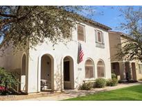 Charming two-story home with stucco exterior, arched entryways, and a well-manicured lawn at 3518 S Posse Trl, Gilbert, AZ 85297