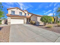 Two-story home featuring a two car garage, desert landscaping, and solar panels on the roof at 3614 W Alyssa Ln, Phoenix, AZ 85083