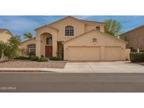 Inviting two-story home featuring a three-car garage and arched entryway at 5771 W Gail Dr, Chandler, AZ 85226