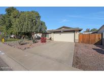 Charming single-Gathering home featuring a well-maintained yard, long driveway, and inviting two-car garage at 7132 W Vermont Ave, Glendale, AZ 85303