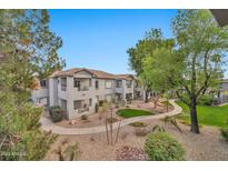 Inviting condo complex featuring well-maintained landscaping and multiple levels with balconies at 7401 W Arrowhead Clubhouse Dr # 2012, Glendale, AZ 85308