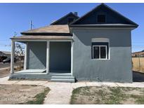 Charming exterior view of a well-maintained, two-story home with a covered porch and stylish architectural details at 824 S 3Rd Ave, Phoenix, AZ 85003