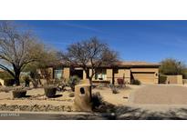 Charming, single-story home featuring desert landscaping and a private driveway on a sunny day at 8386 E Arroyo Seco Rd, Scottsdale, AZ 85266