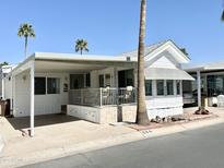 Charming single-story home with covered parking, a front patio, and desert landscaping at 864 S Motherlode Dr, Apache Junction, AZ 85119