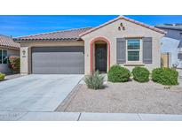 Charming single-story home featuring a tile roof, desert landscaping and two-car garage at 10730 W Escuda Dr, Peoria, AZ 85373
