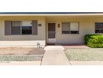 Inviting single-story home featuring a well-maintained front yard and a cozy entrance with decorative touches at 13642 N Silverbell Dr, Sun City, AZ 85351