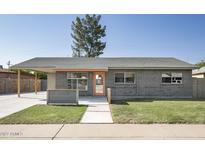Charming single-story home featuring a well-maintained lawn and a covered carport at 1432 W 7Th St, Tempe, AZ 85281