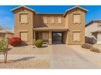 Charming two-story townhome features a desert landscape and covered entryway at 16510 W Tether Trl, Surprise, AZ 85387