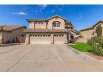 Two story home featuring a three car garage, desert landscaping, and a tile roof at 314 W Loma Vista St, Gilbert, AZ 85233