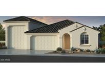 Charming single-story stucco home featuring a tile roof, front-facing garage, and a landscaped front yard at 5206 W Top Hand Trl, Laveen, AZ 85339