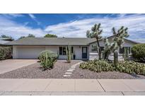 Charming single-story home featuring desert landscaping, gravel yard, and a welcoming walkway at 6820 E Pinchot Ave, Scottsdale, AZ 85251