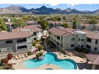 Expansive aerial view of the community pool with mountain views and terracotta tile roofs at 9455 E Raintree Dr # 1009, Scottsdale, AZ 85260