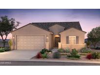 Charming single-story home with a neutral color palette, well-maintained landscaping, and a two-car garage at 17806 W Getty Dr, Goodyear, AZ 85338