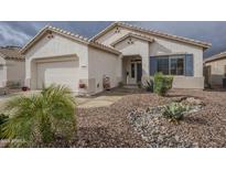 Charming single-story home featuring a landscaped front yard with desert plants and a two-car garage at 18250 N Coconino Dr, Surprise, AZ 85374