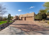 Charming home featuring a spacious driveway, a three-car garage, and desert landscaping at 20212 E Appaloosa Dr, Queen Creek, AZ 85142