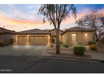 Inviting single-story home showcasing a desert-landscaped front yard and a three-car garage at 2025 W Calle Del Sol --, Phoenix, AZ 85085