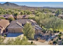 Beautiful home featuring a tile roof, desert landscaping, and a three-car garage at 2025 W Calle Del Sol --, Phoenix, AZ 85085