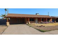 Charming single-story home with carport, covered porch, and landscaping at 2144 W Joan De Arc Ave, Phoenix, AZ 85029