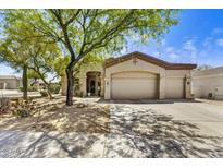 Charming home featuring desert landscaping, a spacious driveway, and a two-car garage at 22503 N 76Th Pl, Scottsdale, AZ 85255