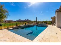 Inviting backyard oasis with pool, spa, and views of golf course and mountains at 26231 W Maple Dr, Buckeye, AZ 85396