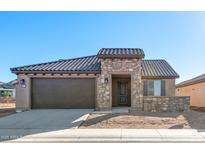 Beautiful single-story home featuring a stone facade, tile roof, and attached two-car garage at 26905 W Mcrae Dr, Buckeye, AZ 85396