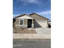 Charming single-story home featuring a two-car garage, stone accents, and low-maintenance landscaping at 4038 E San Jose St, San Tan Valley, AZ 85143