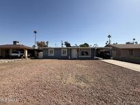 Single story home with a gravel yard, carport, and neutral color scheme at 4221 N 33Rd Dr, Phoenix, AZ 85017