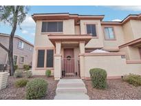 Charming two-story townhome with a landscaped front yard and welcoming entrance at 42424 N Gavilan Peak Pkwy # 30104, Anthem, AZ 85086