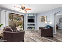 Comfortable living room with a ceiling fan and sliding glass door to a patio area at 705 W Queen Creek Rd # 1059, Chandler, AZ 85248