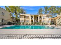 Exterior view of community pool, deck and two-story buildings on a sunny day at 925 S Longmore -- # 124, Mesa, AZ 85202